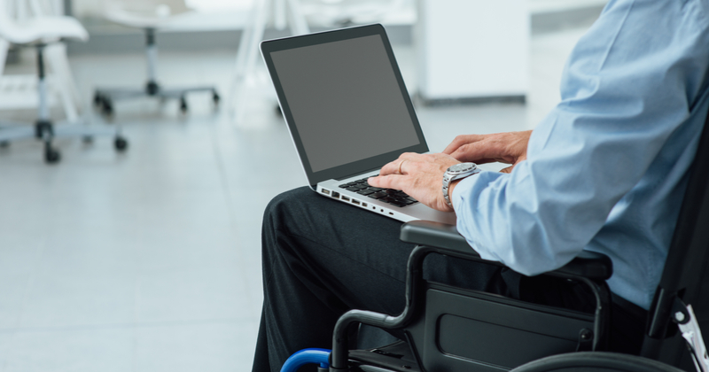 Man in wheelchair and holding laptop: How to Make Your Website Accessible for Everyone: What Small Business Owners Need to Know | Anthony Caliendo | The Sales Assassin
